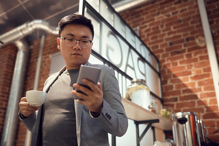 Asian Man Typing Text Message