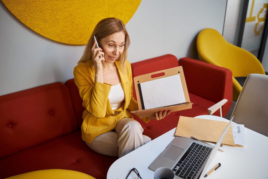 Cheerful blonde business lady having pleasant conversation