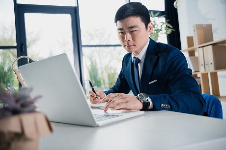 young asian businessman working with laptop