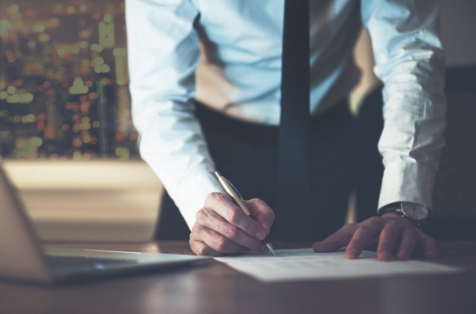 Close up business man signing contract making a deal, classic business